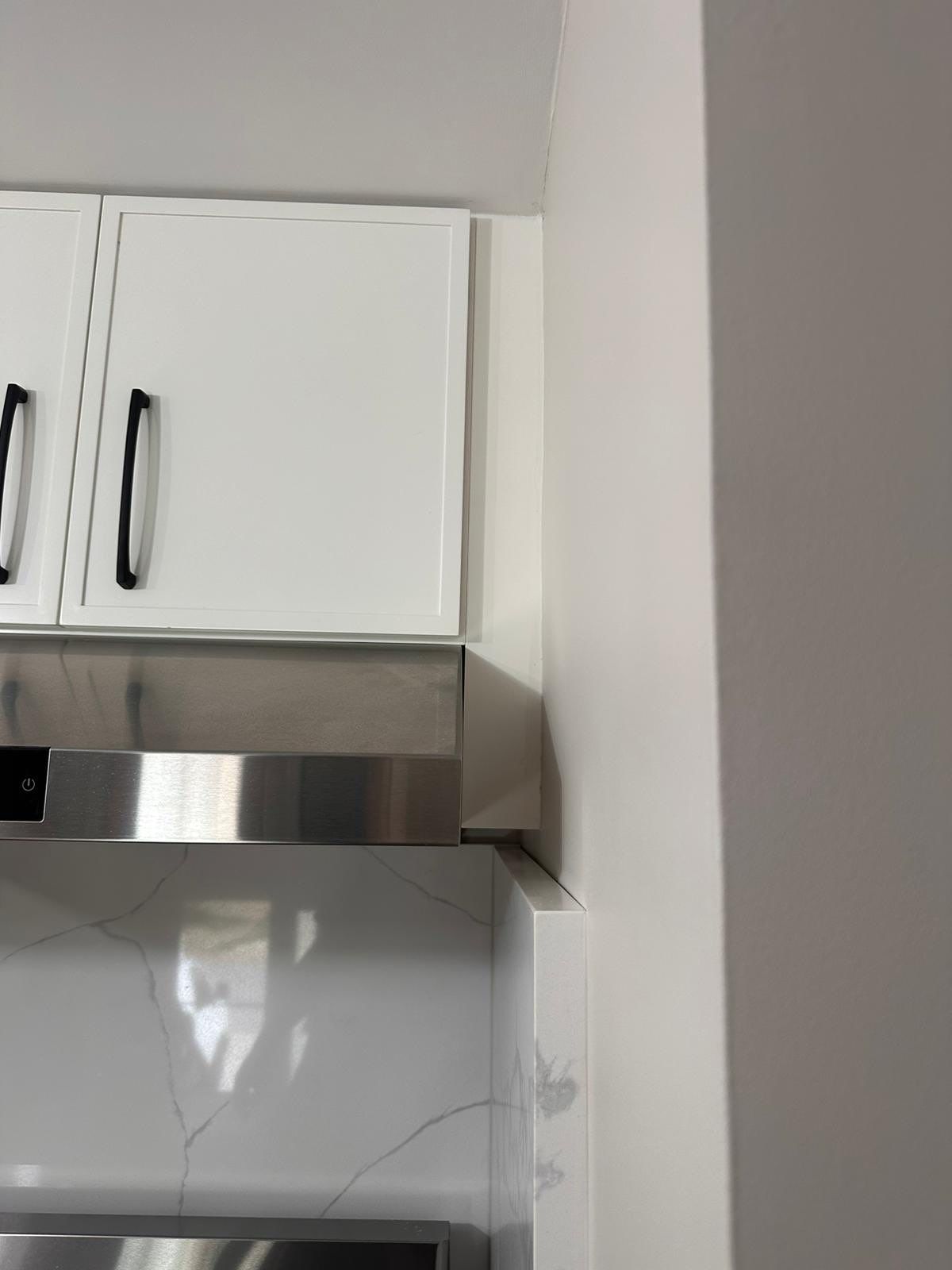 Bridgewater kitchen remodel featuring white shaker upper cabinets with black hardware and stainless steel built-in appliance with digital controls.